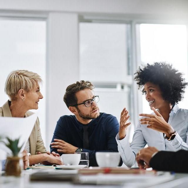 Three colledues discussing in a workplace